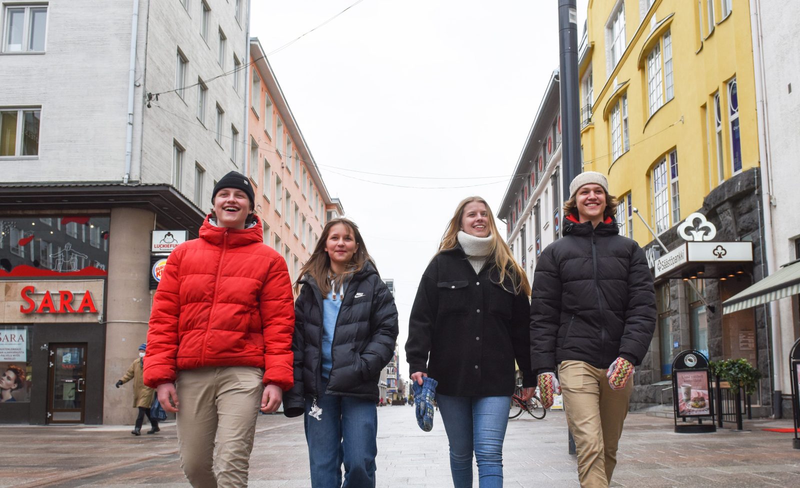 Young people are walking on Rotuaari towards the camera.